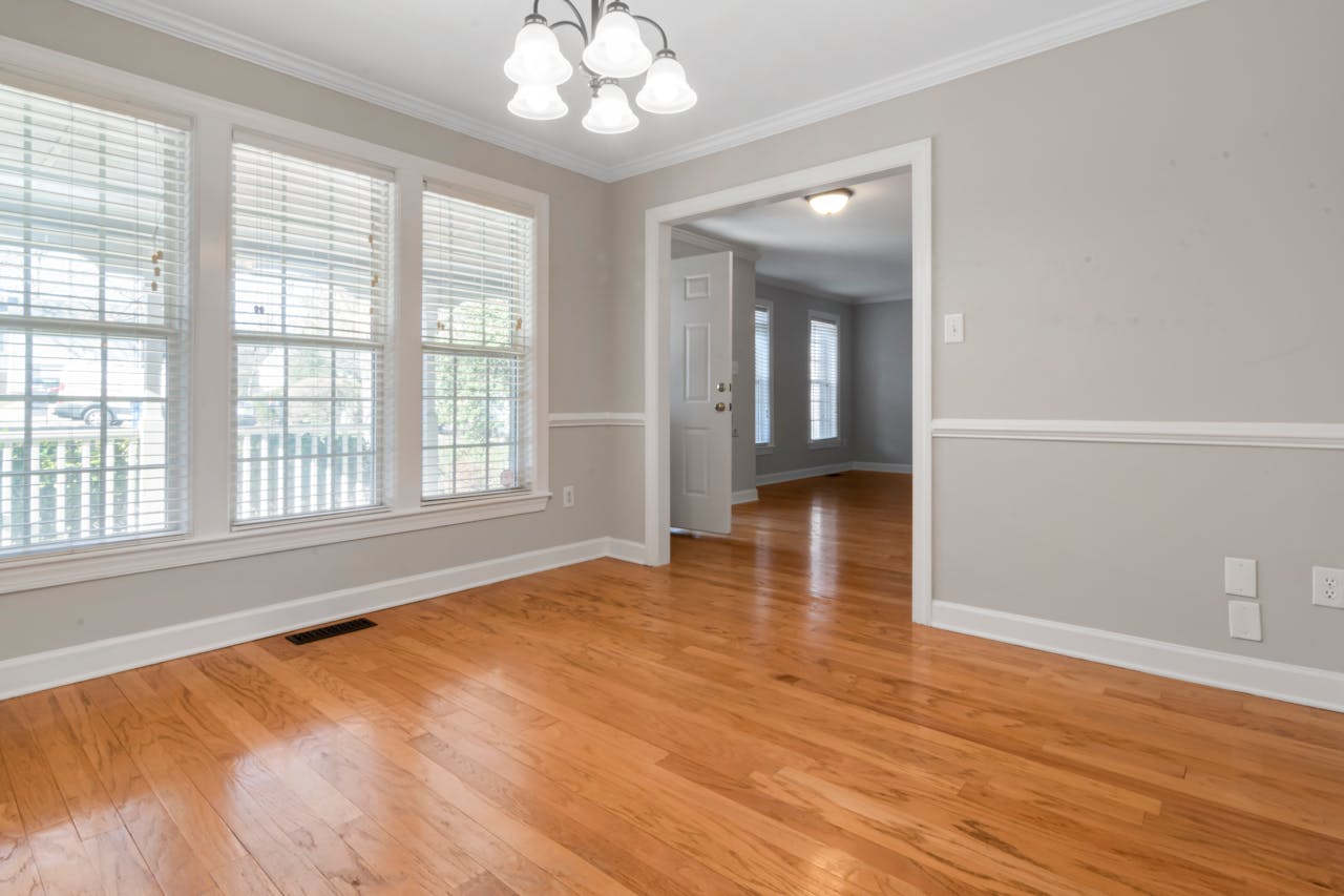 The Role of the Residential Project Manager in Home Construction Bright minimalist room with wooden flooring and large windows, ideal for interior design inspiration.